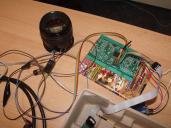 For testing, we used simple RS232 communication while the lens were powered indirectly via the firmware programmer. A bit messy but works reliably. Some other stuff, for instance, earphone cables are also there, just for military deception. 